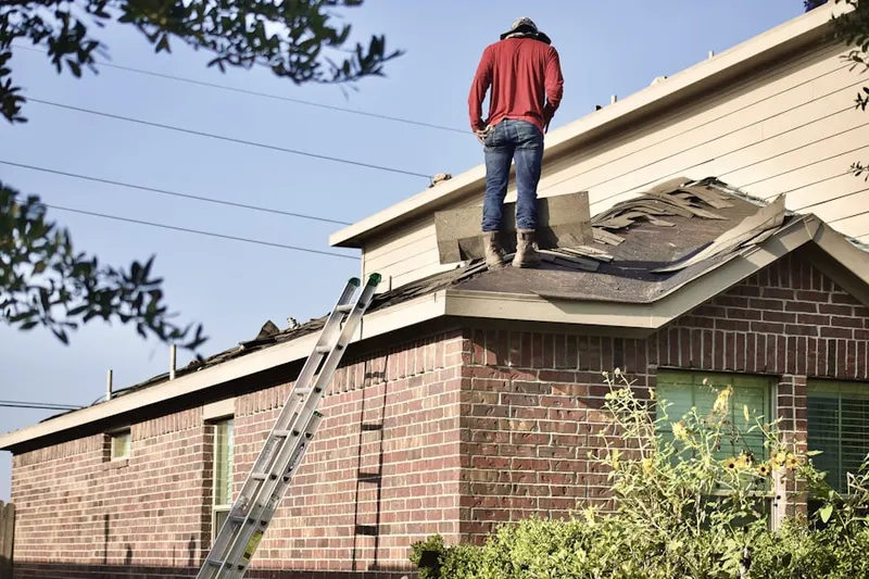 Professional roofer working on a residential roof in Lyonstown